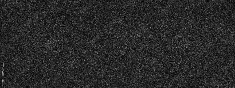 Black abstract background. Concrete wall finished with marble chips. Black stone background with copy space for design. Wide web banner. Black abstract background. Concrete wall finished with marble chips. Black stone background with copy space for design. Wide web banner.