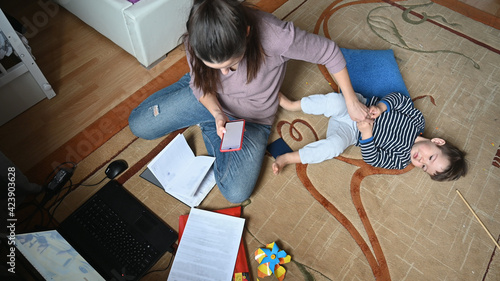The child interferes with the mother's work at the computer