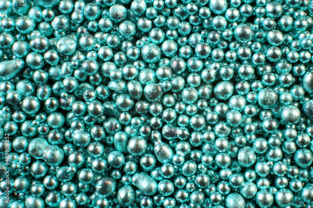 A background of many shiny metallic balls of turquoise color. A background of many shiny metallic balls of turquoise color.