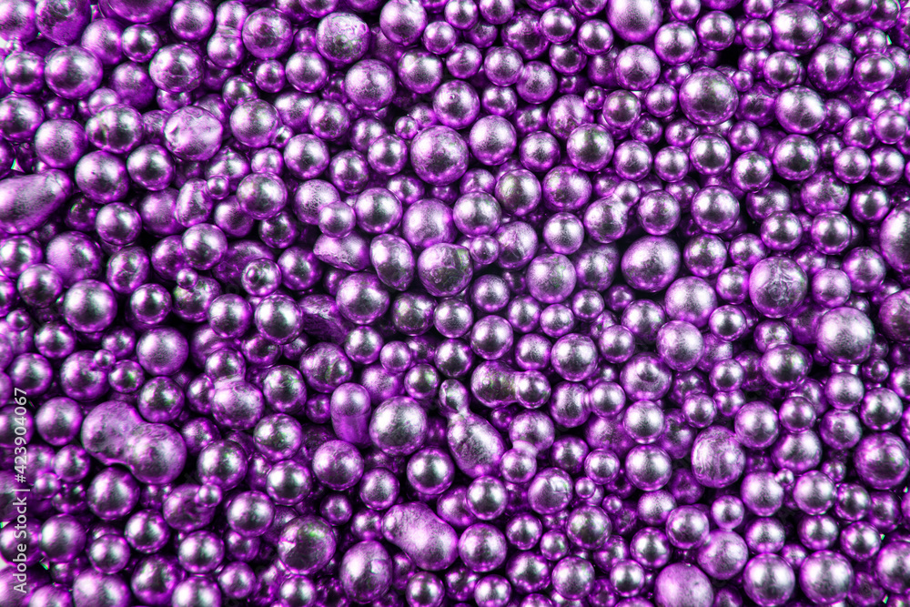 A background of many shiny purple metallic balls. Metallic balls of amethyst color. A background of many shiny purple metallic balls. Metallic balls of amethyst color.