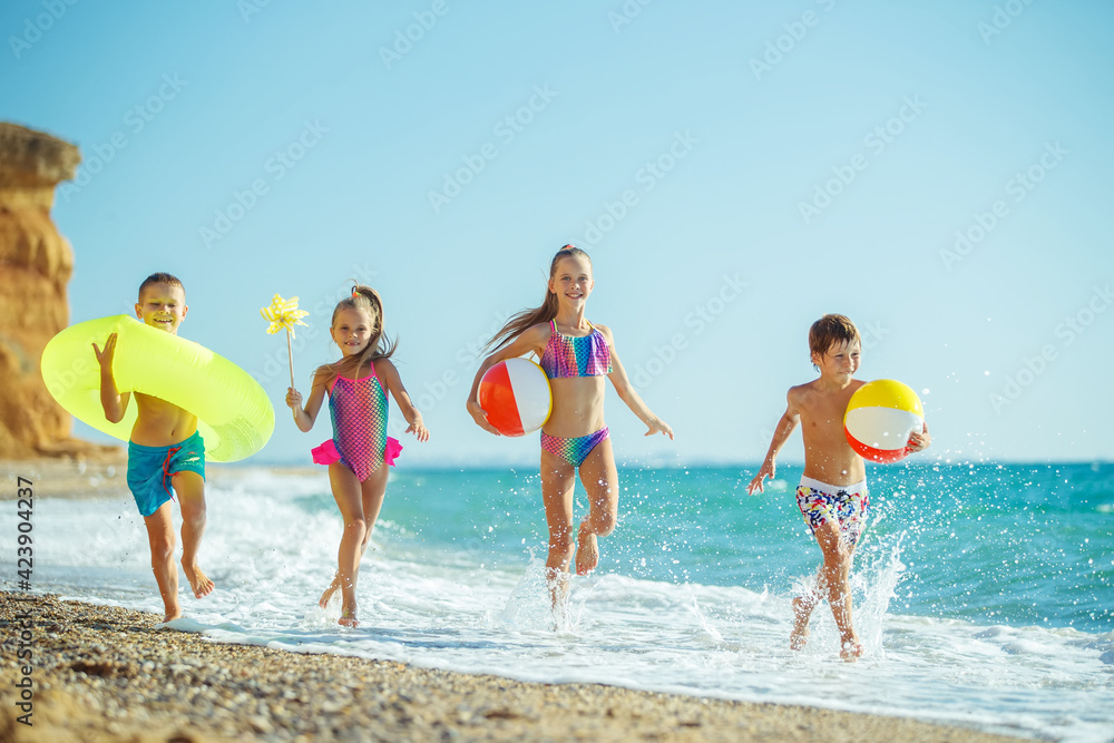 Children have fun on the sandy beach in summer. High quality photo.