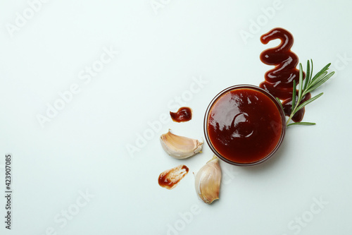 Bowl of barbecue sauce and spices on white background photo