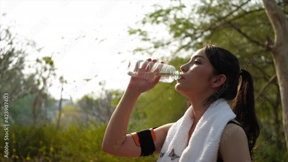 Sport woman taking a break and drinking water from bottle. Sport woman taking a break and drinking water from bottle.