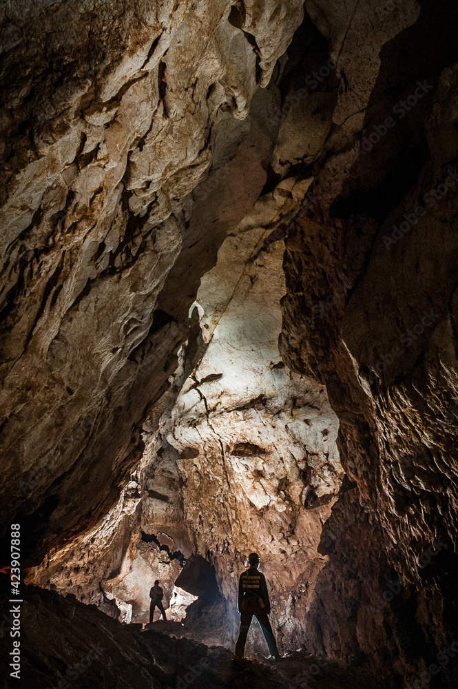 Speleologists exploring a deep cave