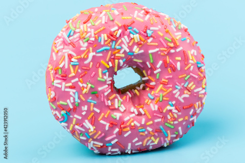 Fresh made Donuts isolated on blue background. Doughnuts are traditional sweet pastries. Copy space for text.