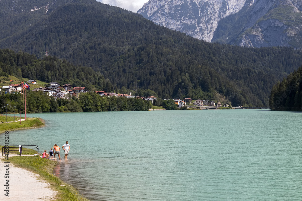 AURONZO DI CADORE, VENETO/ITALY - AUGUST 9 : View of Santa Caterina Lake at Auronzo di Cadore, Veneto, Italy on August 9, 2020. Four unidentified people