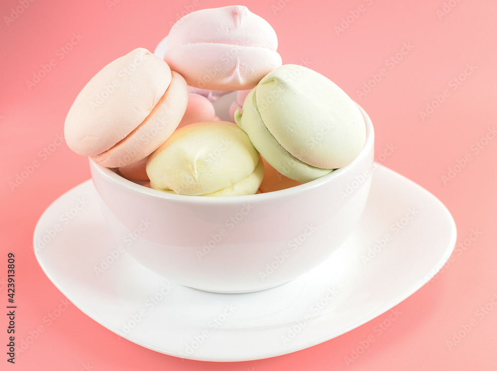 Fruit marshmallows on a plate as breakfast. Natural colored marshmallows on a pink background. Selective focus. Fruit marshmallows on a plate as breakfast. Natural colored marshmallows on a pink background. Selective focus.