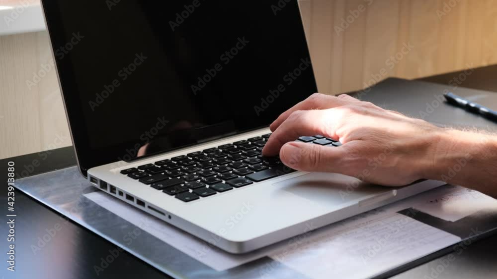 hand working on laptop keys hand working on laptop keys