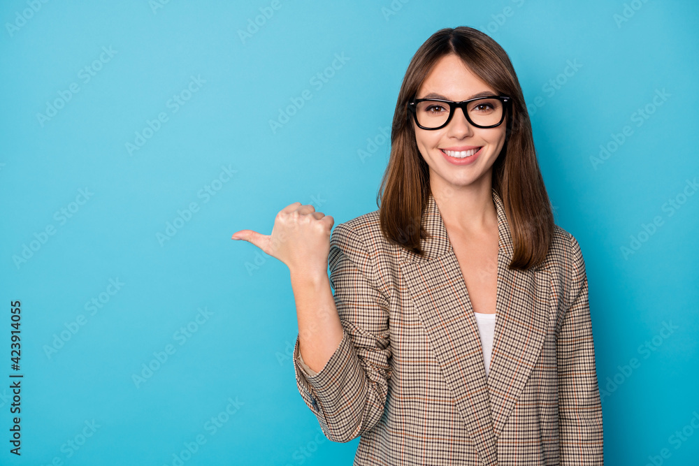 Portrait of brunette optimistic lady point empty space wear spectacles brown blazer isolated on bright blue color background Portrait of brunette optimistic lady point empty space wear spectacles brown blazer isolated on bright blue color background