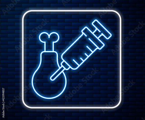 Glowing neon line Gmo research chicken icon isolated on brick wall background. Syringe being injected to chicken. Vector