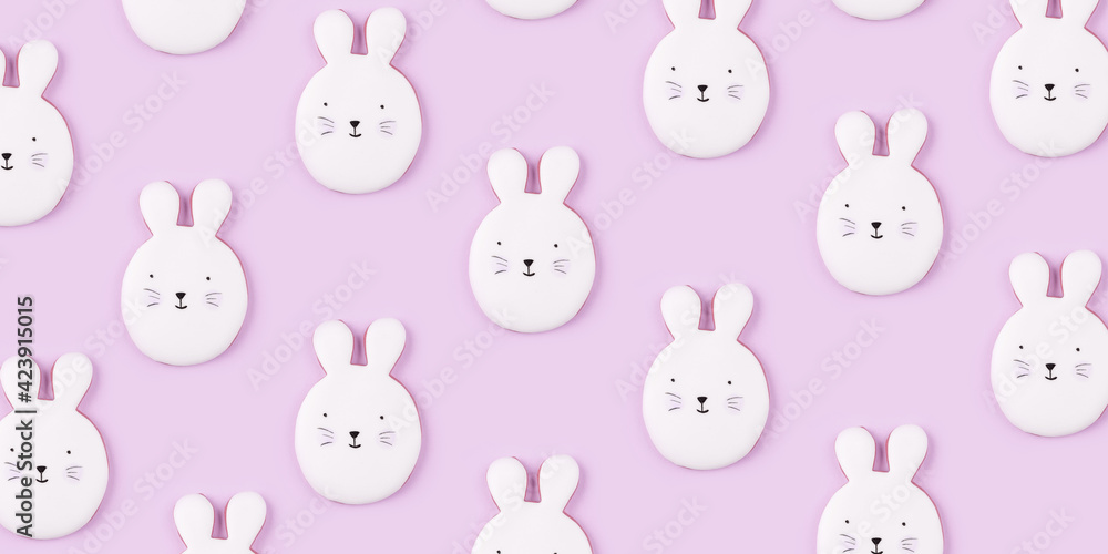 Pattern of Easter bunny cookies on lilac background. Spring holiday.