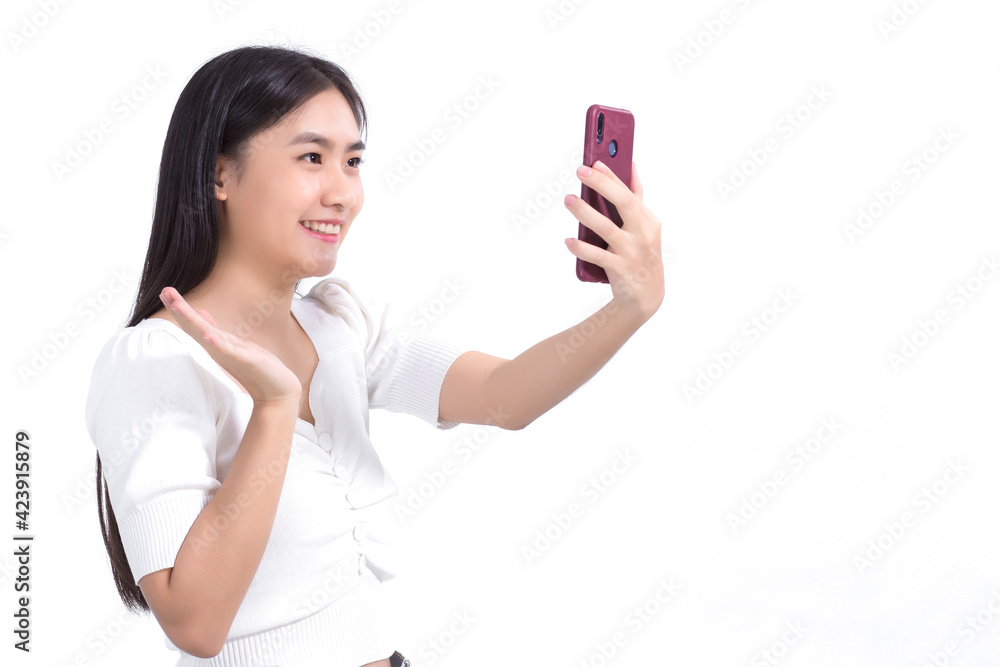 Asian beautiful woman using a smartphone for video calling to Talk happily with a friend on a white background. Asian beautiful woman using a smartphone for video calling to Talk happily with a friend on a white background.
