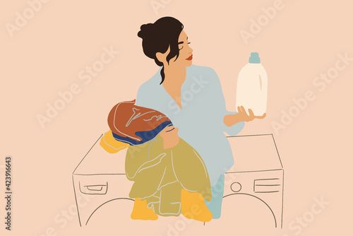 A pretty woman looking on detergent in big white bottle and holding colored clothes on laundry background. Housewife doing routine. Flat style. Vector illustration