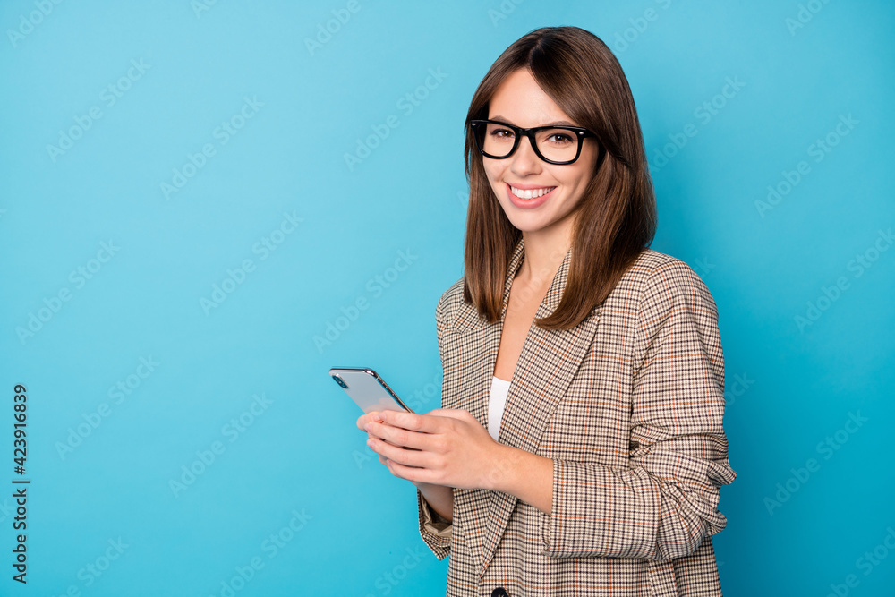 Profile photo of optimistic brunette lady look telephone wear spectacles brown jacket isolated on vivid blue background Profile photo of optimistic brunette lady look telephone wear spectacles brown jacket isolated on vivid blue background