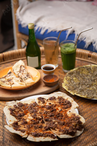 Middle eastern or arabic dishes and assorted meze: hummus, pita, Manakish Lahm Bi Ajeen - Flatbreads topped with minced meat and Fatayer stuffed pie. Halal food photo