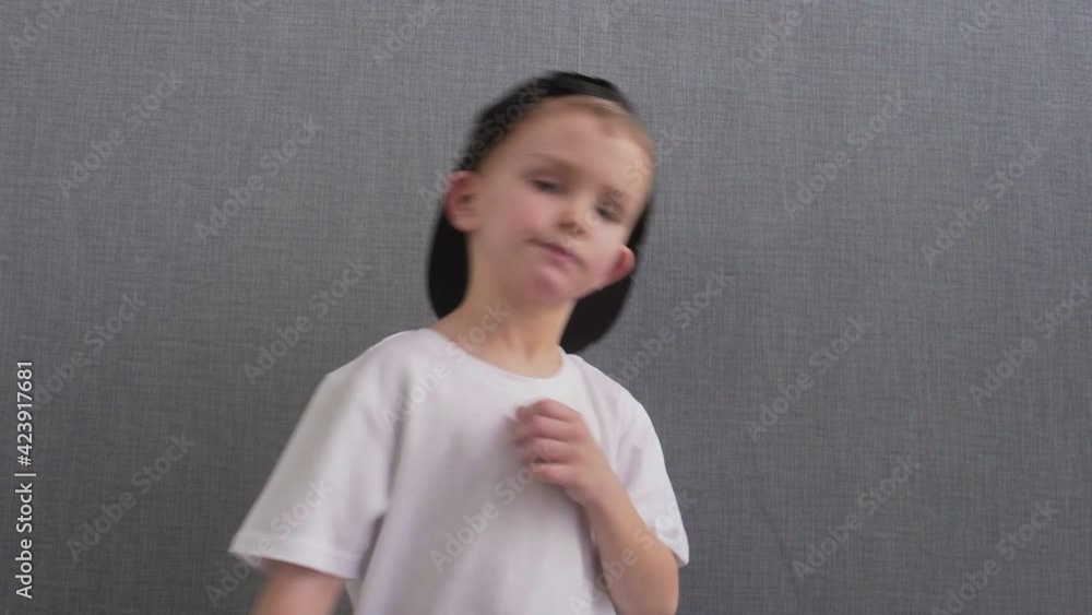 Charming Caucasian boy dancing jumping. Expression of talent and hobby. Happy childhood. Teenager boy listening to music and dancing in Rhythm Charming Caucasian boy dancing jumping. Expression of talent and hobby. Happy childhood. Teenager boy listening to music and dancing in Rhythm