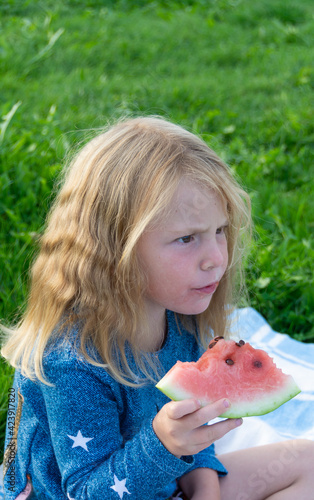 Children enjoy eating delicious  red  ripe  juicy  appetizing watermelon. 