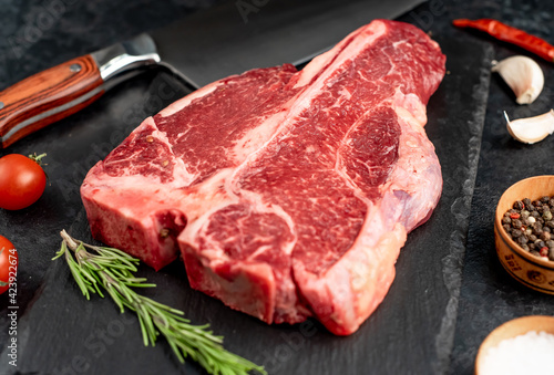 raw T-Bone Beef Steak on stone background