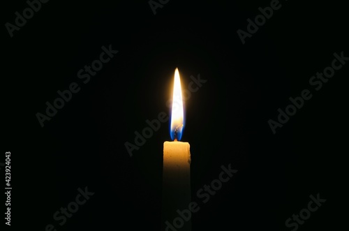 Burning candle in the dark