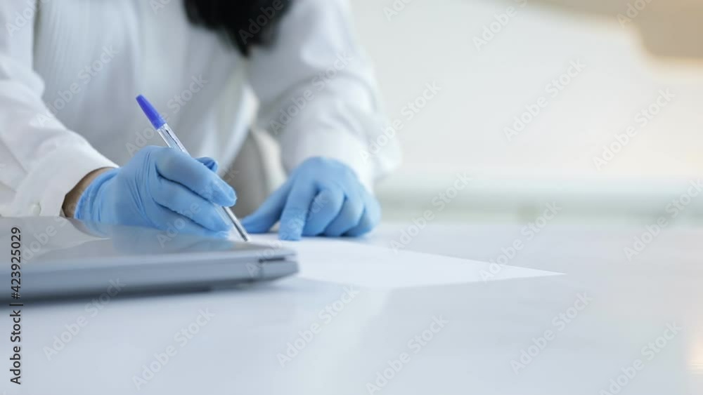 close up of a doctor working on a computer close up of a doctor working on a computer
