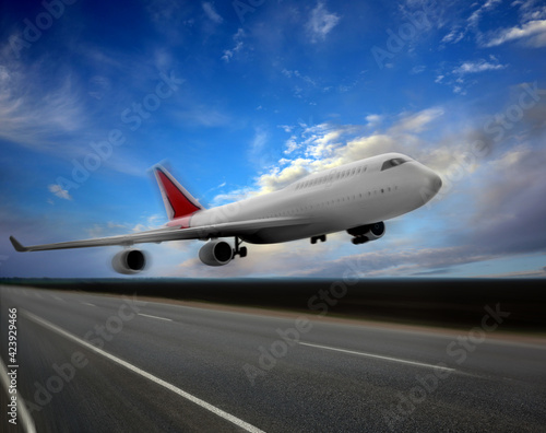 Modern white airplane landing on runway