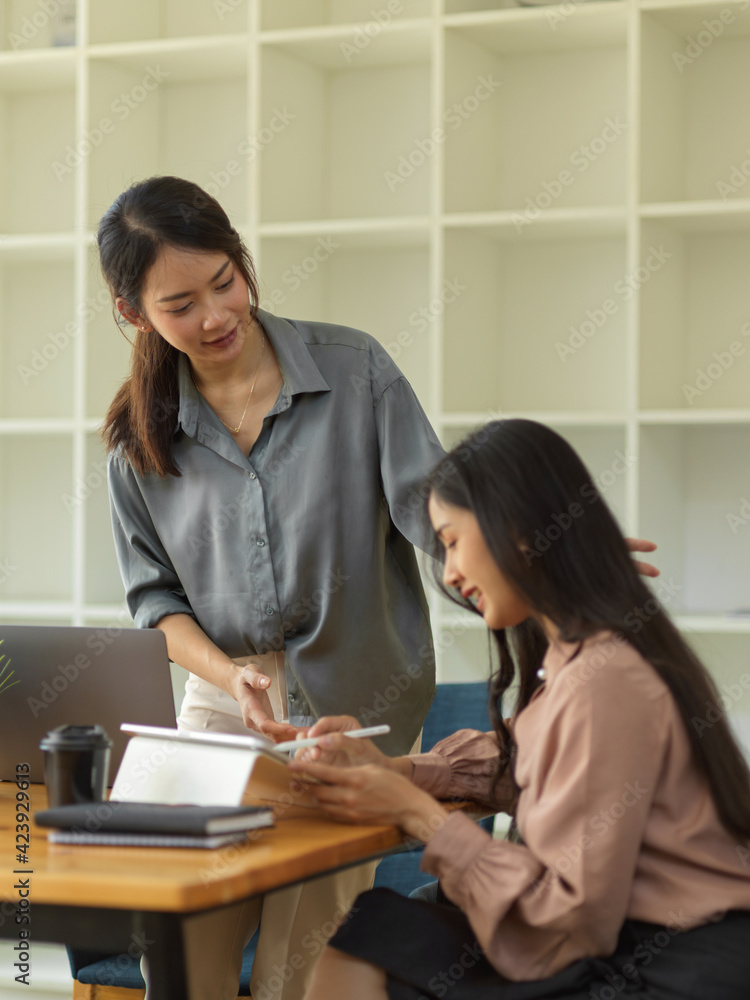 Quarter-length portrait of female senior giving advice to her underling Quarter-length portrait of female senior giving advice to her underling