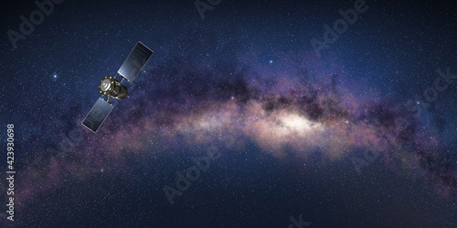 Fototapeta Naklejka Na Ścianę i Meble -  Research satellite in the outer space with te Milky Way in background. 3D illustration