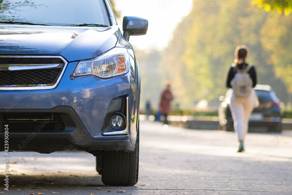Fototapeta premium New clean car parked on a city street side.