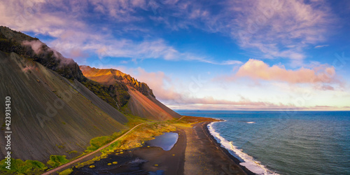 Aerial view of a black sand beach and the Eystrahorn Mountains in Iceland