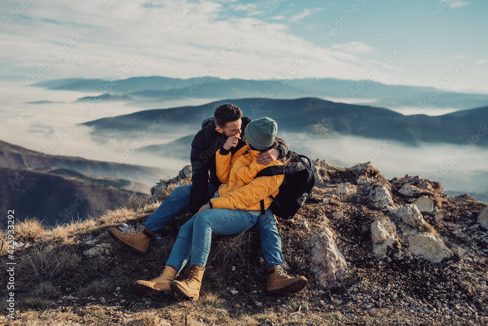 Fototapeta premium happy couple man and woman tourist at top of mountain during a hike in summer