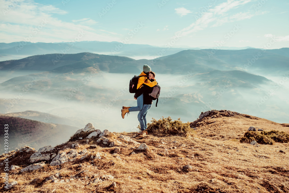happy couple man and woman tourist at top of mountain during a hike in summer happy couple man and woman tourist at top of mountain during a hike in summer