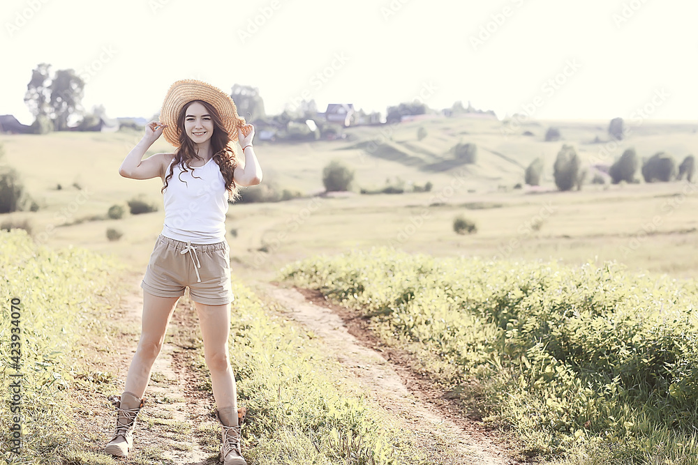 young happy european model / summer vacation, a walk in nature in the summer landscape, an adult girl alone