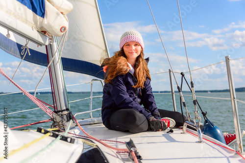 young woman sit on sailboat bow