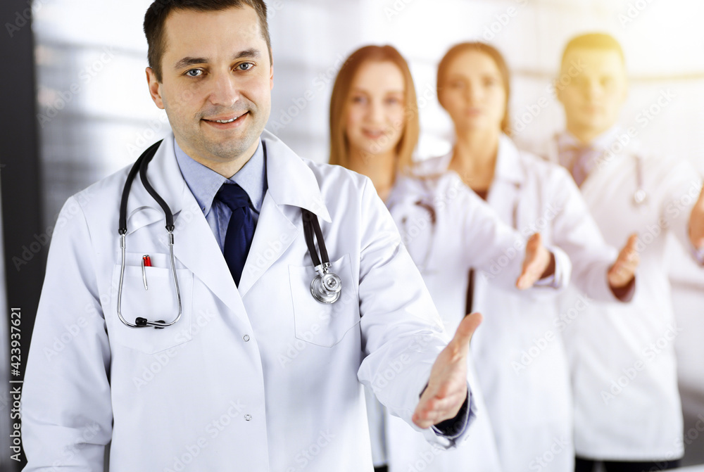 Team of friendly professional doctors are offering their helping hand for the people in a sunny clinic. Physicians are ready to help their patients. Best medicine concept nowadays Team of friendly professional doctors are offering their helping hand for the people in a sunny clinic. Physicians are ready to help their patients. Best medicine concept nowadays