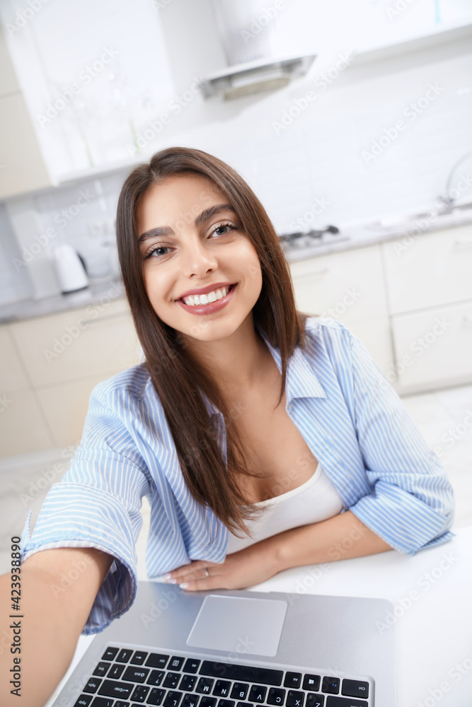 Smiling woman working in laptop at home. Smiling woman working in laptop at home.