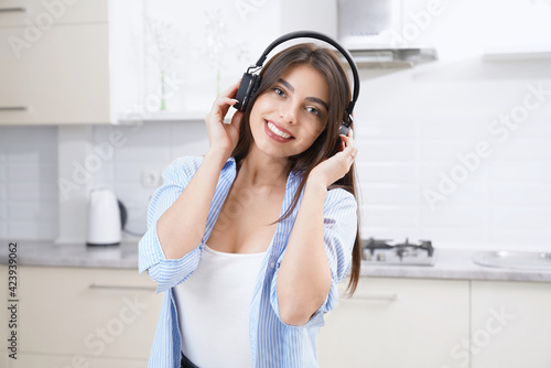 Smiling woman listening musin in headphone. photo