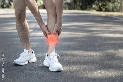 young runner is suffering from shin splints
 photo