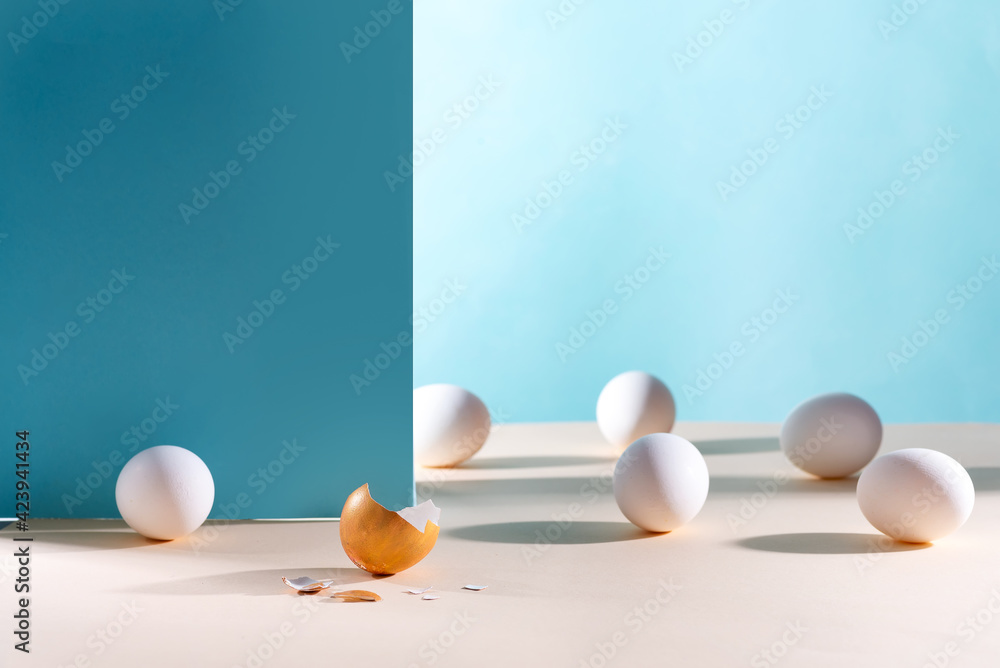 Fototapeta premium Easter background. White eggs with golden shell on a blue background