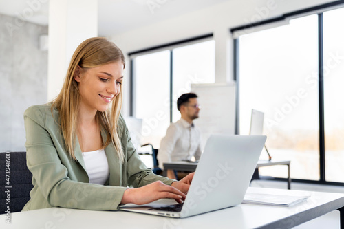 Smiling professional business woman working in corporate office