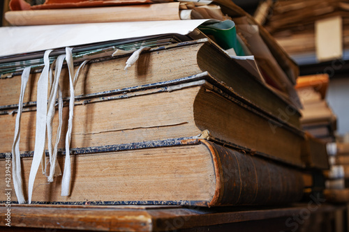 Several old books on a table in a library photo