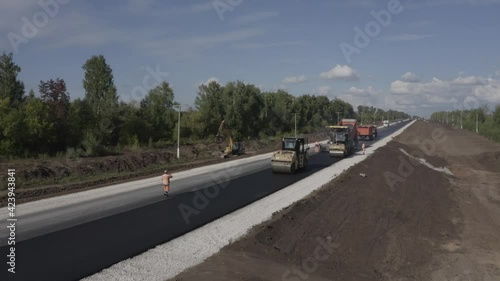 The copter takes off over the road on which the asphalt is laid