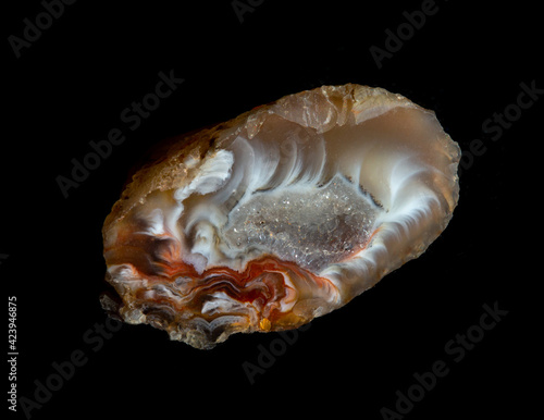 Fotografija Raw agate quartz minerals nugget with crystals inside isolated on black background