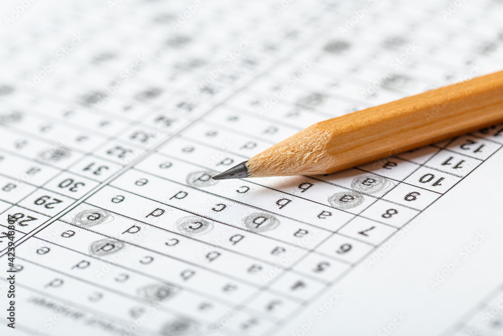 testing in exercise and exam paper. computer sheet with pencil in school test room, education concept. filling in answers in pencil testing in exercise and exam paper. computer sheet with pencil in school test room, education concept. filling in answers in pencil