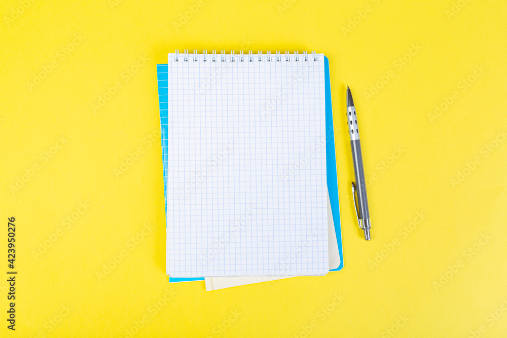 open notepad on yellow background with pencil on top, spiral notepad with blank sheet. open notepad on yellow background with pencil on top, spiral notepad with blank sheet.