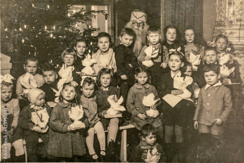 Germany - CIRCA 1940s: Group photo of small kids girls boys and Santa Claus on Christmas New Year Eve party. Vintage archive Art Deco era photography