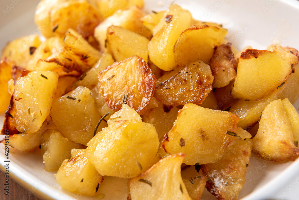 Piatto di patate cotte al forno con rosmarino, Cucina italiana Piatto di patate cotte al forno con rosmarino, Cucina italiana