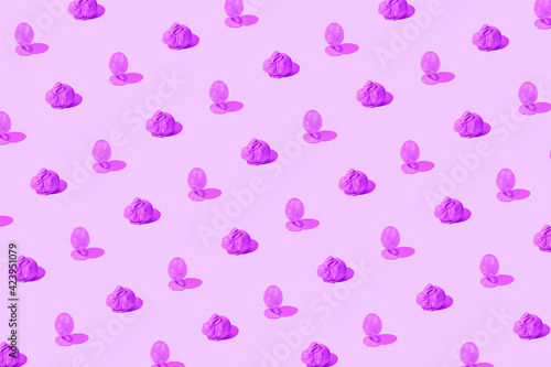 Easter pattern made of pink glittering eggs and bunny on pastel background. Festive concept