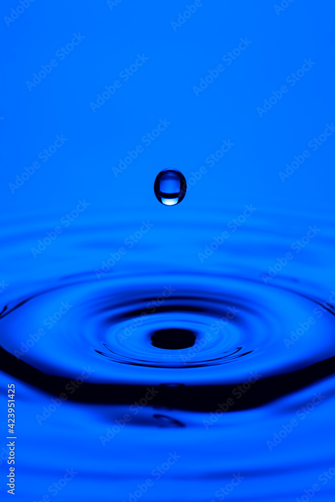 Closeup Shot of Abstract Blue Water Splash or Rain Drop Falling on Water Surface. Closeup Shot of Abstract Blue Water Splash or Rain Drop Falling on Water Surface.