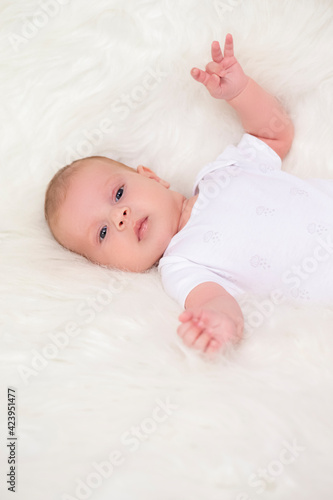 Newborn Baby Concepts. Portrait of Caucasian Newborn Boy Lying on Bed With Lifted Outstretched Hands. Macro Shoot.