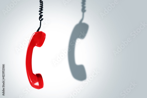 Obraz na plátne Red telephone handset with a dark shadow